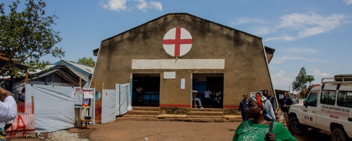 View from the old Lita Hospital building, showing a woman walking toward the Ebola Traitment Center. Photo by Akilimali Chomachoma